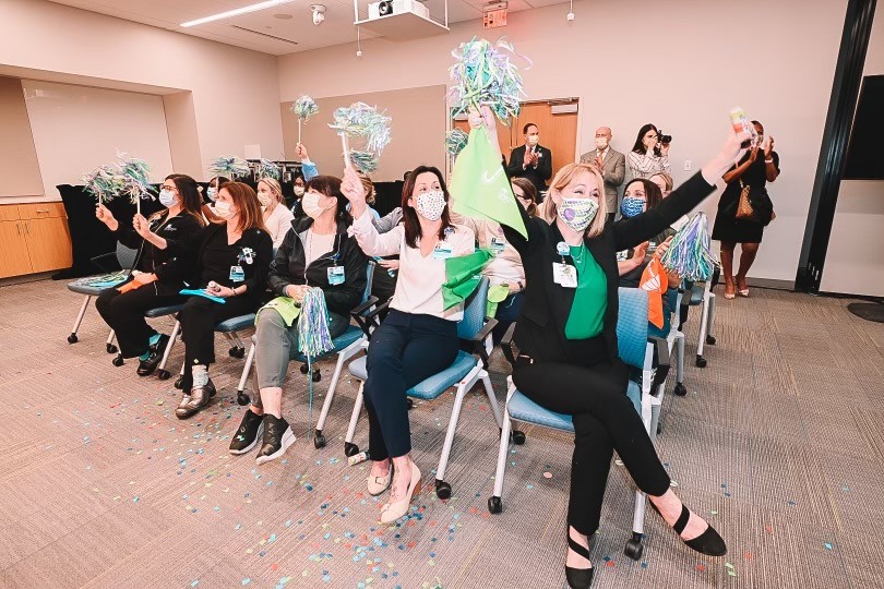 group of women cheering in a conference room